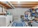 Unfinished basement laundry area with washer, dryer, and storage shelves at 11203 Dexter St, Thornton, CO 80233