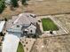 Aerial view of a two-story house with a large backyard, playground, and three-car garage at 1221 W 144Th Ct, Westminster, CO 80023