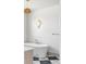 Modern freestanding bathtub with stylish fixtures and geometric tile, illuminated by a decorative light fixture at 1221 W 144Th Ct, Westminster, CO 80023