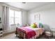 Bright bedroom featuring a single bed with gold frame, decorative pillows and a window with natural light at 1221 W 144Th Ct, Westminster, CO 80023