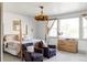 Serene bedroom featuring a four-poster bed, sitting area, neutral colors, and plenty of natural light at 1221 W 144Th Ct, Westminster, CO 80023