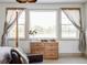 Sunlit bedroom featuring large windows, wood dresser, and relaxed decor with a blend of textures and colors at 1221 W 144Th Ct, Westminster, CO 80023