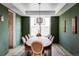 Formal dining room with green walls, tray ceiling, and elegant table setting at 1221 W 144Th Ct, Westminster, CO 80023
