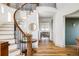 Staircase and entryway with wood floors, black metal railings, and access to dining area at 1221 W 144Th Ct, Westminster, CO 80023