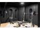 Home gym with black walls and ceiling, mirrored accents, and weights at 1221 W 144Th Ct, Westminster, CO 80023