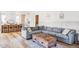 Living Room with gray sectional sofa, wooden coffee table, and hardwood floors at 1221 W 144Th Ct, Westminster, CO 80023