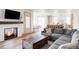 Open-concept living room showcasing fireplace, wood floors, and access to the kitchen at 1221 W 144Th Ct, Westminster, CO 80023