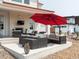 Outdoor patio area with comfortable seating, an umbrella, and an outdoor fireplace at 1221 W 144Th Ct, Westminster, CO 80023