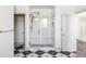 Luxurious walk-in shower with glass enclosure, white subway tile, and modern gold fixtures, plus a built-in bench at 1221 W 144Th Ct, Westminster, CO 80023