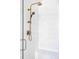 Close-up of shower with white subway tile, bronze fixtures including shower head, and built in bench at 1221 W 144Th Ct, Westminster, CO 80023