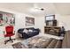 Basement living room with a cozy seating area, TV, and decorative rug at 7146 Jennie Dr, Denver, CO 80221