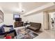Basement living room featuring a seating area, a TV, and a patterned rug at 7146 Jennie Dr, Denver, CO 80221