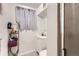 Cozy bathroom featuring a vanity with a sink and a shower/tub, complemented by a window with privacy curtains at 7146 Jennie Dr, Denver, CO 80221