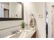 Bathroom featuring a sink with a wooden vanity, a mirror, and tiled backsplash at 7146 Jennie Dr, Denver, CO 80221