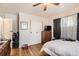 Bedroom featuring hardwood floors, closet, and window dressed with patterned curtains at 7146 Jennie Dr, Denver, CO 80221