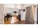 Open concept kitchen with adjacent living and dining areas, featuring bright cabinetry and stainless steel appliances at 7146 Jennie Dr, Denver, CO 80221