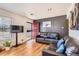 Inviting living room featuring hardwood floors, comfortable sofas, and abundant natural light streaming through large windows at 7146 Jennie Dr, Denver, CO 80221