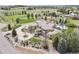 Expansive estate aerial view features a circular driveway, manicured lawn, swimming pool and lush landscaping at 7390 Sagebrush Dr, Parker, CO 80138