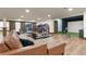 Spacious finished basement with a leather sofa, arcade games, and golf simulator at 7390 Sagebrush Dr, Parker, CO 80138