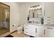 Elegant bathroom featuring granite countertops, a glass shower, and plenty of storage in the white cabinets at 7390 Sagebrush Dr, Parker, CO 80138