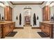 A luxurious bathroom with dual vanities, an arched doorway, and tiled floors at 7390 Sagebrush Dr, Parker, CO 80138