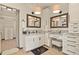 Bright bathroom featuring granite counters, double vanity, framed mirrors, and custom white cabinetry at 7390 Sagebrush Dr, Parker, CO 80138