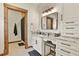 Well-appointed bathroom with granite countertops, white cabinets, and a shower for a spa-like experience at 7390 Sagebrush Dr, Parker, CO 80138