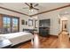 Spacious bedroom with French doors to a balcony, wood trim, and a large bed for ultimate comfort at 7390 Sagebrush Dr, Parker, CO 80138