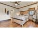 Charming bedroom with wood trim, ceiling fan, and a cozy bed, creating a relaxing retreat at 7390 Sagebrush Dr, Parker, CO 80138