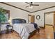 Comfortable bedroom with a large bed, wood floors, and stylish decor, perfect for relaxation at 7390 Sagebrush Dr, Parker, CO 80138