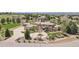 Stately stone and stucco home featuring a circular driveway and mature landscaping at 7390 Sagebrush Dr, Parker, CO 80138