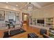 A modern home office with custom millwork, beamed ceilings, a glass desk and hardwood floors at 7390 Sagebrush Dr, Parker, CO 80138