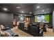 A home theater with tiered seating, a large screen, and a popcorn machine for entertainment at 7390 Sagebrush Dr, Parker, CO 80138