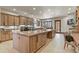 Spacious laundry room boasts a large island, wood cabinets, laundry machines and a doorway to the outside at 7390 Sagebrush Dr, Parker, CO 80138