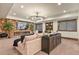 Inviting living room with a stone accent wall, fireplace, and custom built-in shelving for a cozy space at 7390 Sagebrush Dr, Parker, CO 80138