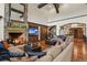 Cozy living room boasts a stone fireplace, wooden beams, and custom built-ins at 7390 Sagebrush Dr, Parker, CO 80138
