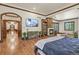 Spacious bedroom with a fireplace, sitting area, hardwood floors, and large windows for natural light at 7390 Sagebrush Dr, Parker, CO 80138
