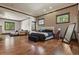 Bright bedroom with a textured wall, multiple windows, hardwood floors, and seating area at 7390 Sagebrush Dr, Parker, CO 80138