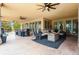 Covered patio with comfortable seating, dining area, and ceiling fans, ideal for outdoor entertaining at 7390 Sagebrush Dr, Parker, CO 80138