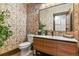 Modern powder room with unique wallpaper, floating vanity, and stylish fixtures with neutral tones at 7390 Sagebrush Dr, Parker, CO 80138