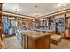 A very large walk-in closet with ample storage, closet island, and overhead lighting at 7390 Sagebrush Dr, Parker, CO 80138