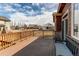 A beautiful view from this cozy back deck with wood railing and a comfortable bench at 5540 Palomino Way, Frederick, CO 80504