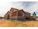 Exterior of home with lush, fenced backyard, spacious back deck and tasteful brick accents at 5540 Palomino Way, Frederick, CO 80504