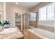 Bright bathroom featuring a soaking tub, tiled shower, double sinks, and a walk-in closet at 5540 Palomino Way, Frederick, CO 80504