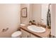 Half bathroom featuring a toilet and vanity at 5540 Palomino Way, Frederick, CO 80504