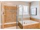 Elegant bathroom featuring a soaking tub, walk-in shower, and tiled walls, offering a spa-like experience at 5540 Palomino Way, Frederick, CO 80504