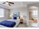 Inviting bedroom with tray ceiling, leading to the Primary bathroom featuring a soaking tub and walk-in shower at 5540 Palomino Way, Frederick, CO 80504