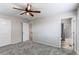 Well-lit bedroom with carpet, a ceiling fan, and access to an attached bath at 5540 Palomino Way, Frederick, CO 80504