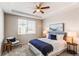 Cozy bedroom with a queen-sized bed, tray ceiling, and large window offering plenty of natural light at 5540 Palomino Way, Frederick, CO 80504