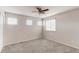Bright bedroom with neutral walls, carpet, ceiling fan and multiple windows at 5540 Palomino Way, Frederick, CO 80504